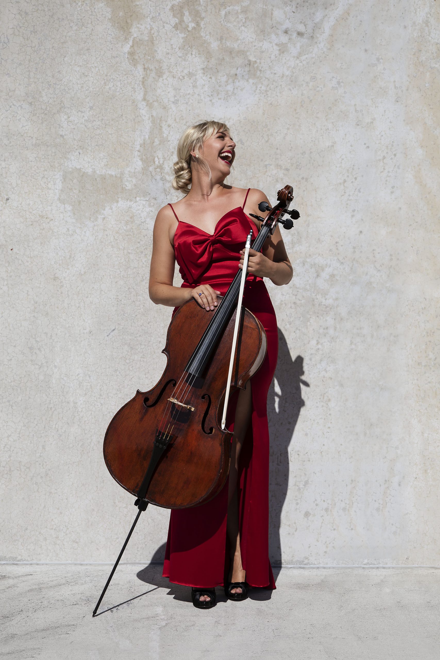 Natalie Helm seated with her cello